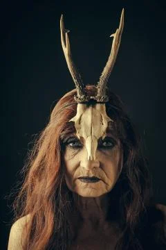 Eldest woman with a creative make. Woman with makeup and antlers. Fashion devil Stock Photos