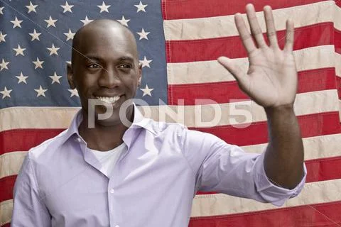 Elected politician waving in front of American flag Stock Photos