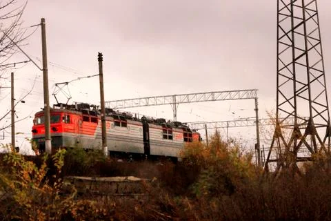 Electic train running by the rails on the fields Stock Photos