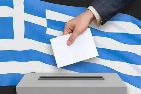 Election in Greece - voting at the ballot box. The hand of man is putting his Ilustração Stock