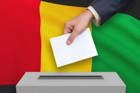 Election in Guinea - voting at the ballot box. The hand of man is putting his Stock-Illustration