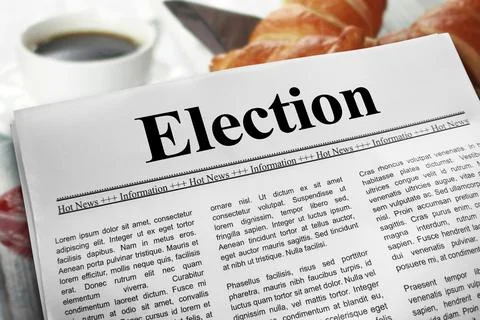 Election in newspaper layout on a breakfast table with a blurry cup of coff.. Stock Photos