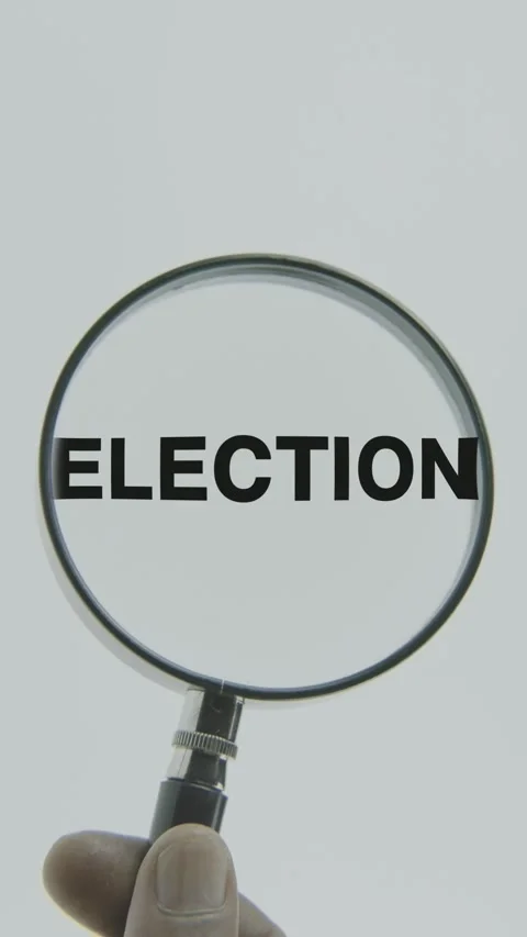 Election text or word highlighted by a magnifying glass in a hand on a white Stock Footage 303438076