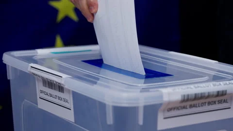 Elections in EU country, voter casting paper ballot in transparent box close-up Stock Footage