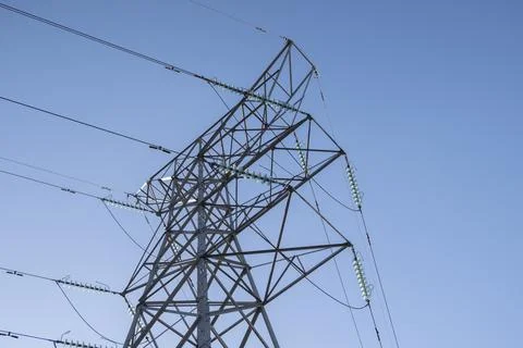 Electircity pylons against a clear blue sky on a cold winters day in stafford Stock Photos