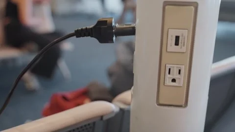 Electric AC socket or outlet dock in airport terminal with cable plugged in Stock Footage 320359793