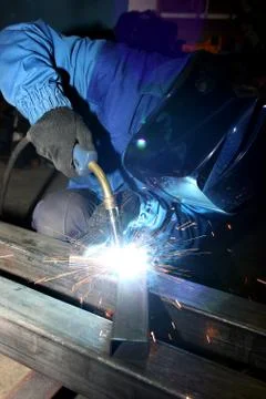 Electric arc welding. The worker welding two iron corners. 库存照片