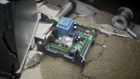 An electric automatic gate control board during repairs. An electric automati Stock Footage 196080862