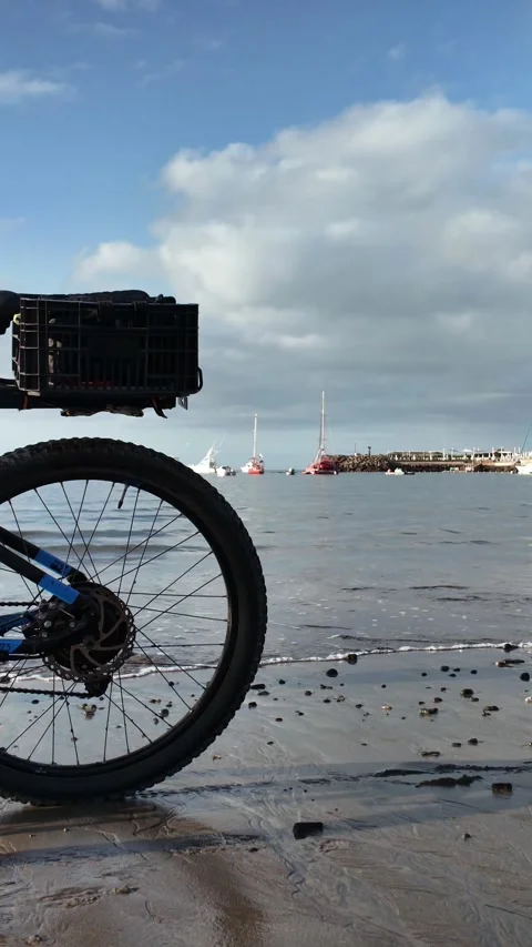 Electric bicycle wheel parked on the beach for a healthy lifestyle Stock Footage 346561468
