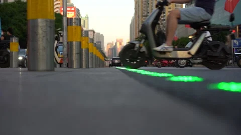 Electric bikes crossing a crossroads while traffic light changes Stockbeeldmateriaal 218471881