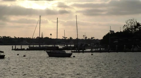 Electric boat passing under cloudy skies as sunset is streaking through.mp4 Stock Footage 67466536