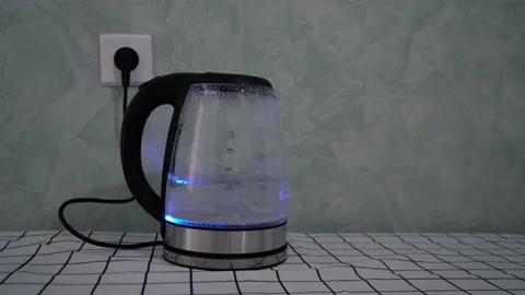 Electric boiling kettle standing on the table Stock Footage 167136397