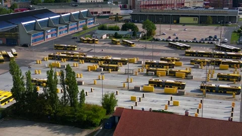 Electric buses charging at depot in Berlin. Majestic aerial view drone Stock Footage 346487942