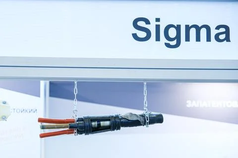 Electric cable joint hanging on display at industrial technology trade fair. Stock Photos