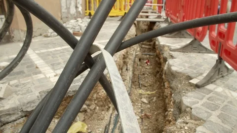 Electric cables coming out of the ground. gutter or ditch or tunnel for the w Stock Footage 109602289