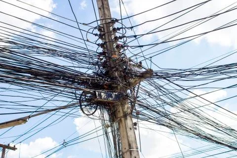 Electric cables tangle on electric pole Stock Photos