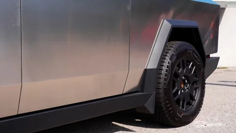 An electric car with an angular design displayed outdoors. Stock Footage 274452435