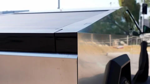 An electric car with an angular design displayed outdoors. Stock Footage 274452443