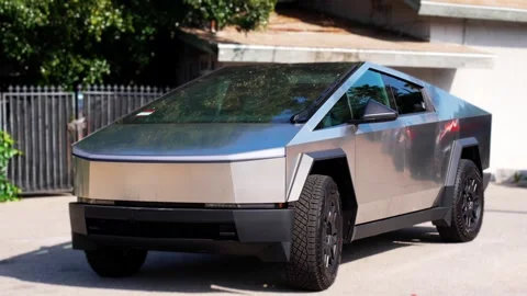 An electric car with an angular design displayed outdoors. Stock Footage 274453029