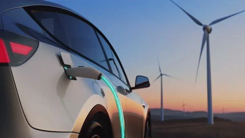 Electric car charging on the background of a windmills. Back view at sunset Stock Footage 166524701
