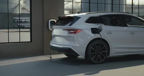Electric car is charging inside an industrial garage Stock Footage 314091612