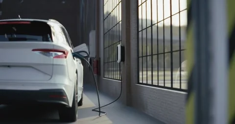 Electric car is charging inside an industrial garage Stock Footage 314271073