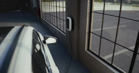 Electric car is charging inside an industrial garage Stock Footage 314322797