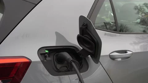 Electric car charging at plug in charge station in a public car park Stock Footage 170657074