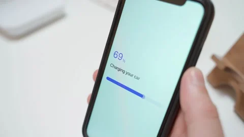 Electric car charging progress on smartphone from zero to fully charged. Stock Footage 342735200