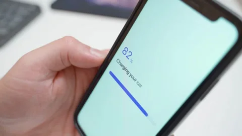 Electric car charging progress on smartphone screen. Fully charged confirmation Stock Footage 343237696