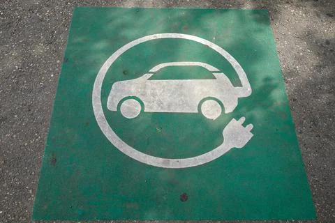 Electric car charging sign on pavement Stock Photos
