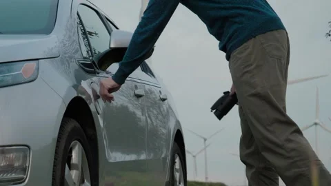 Electric car disconnects charging cable Stock Footage 336008887