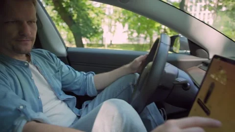 Electric car driver using navigation screen Stock Footage 135725544