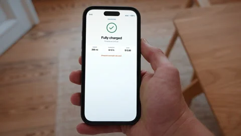 Electric car fully charged confirmation screen on a smartphone, EV charging Stock Footage 346143282