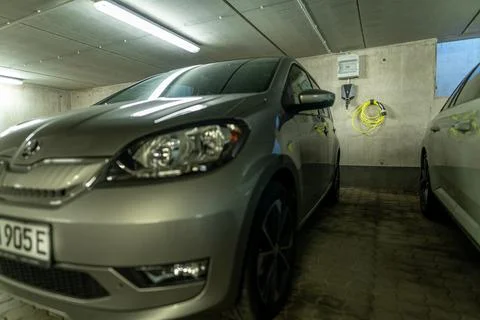 Electric car with its typical E at the number plate and a charging station Stock Photos