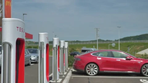 Electric car parks to charge battery at the station Stock Footage