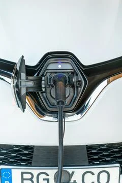 Electric Car Plug Connected to Front Charging Port 写真素材