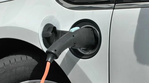 An electric car plugged into a road side charging point, Arnhem, Netherlands. Stock Footage