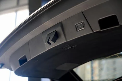 Electric car trunk lock button with trunk closing handle. Rear trunk lock. Stock Photos