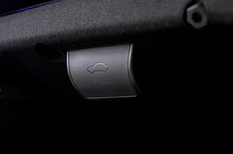 Electric car trunk lock button with trunk closing handle. Rear trunk lock. Stock Photos