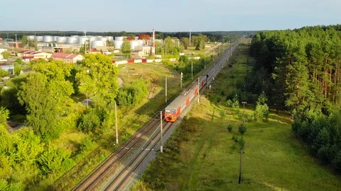 Electric commuter train passing through rural area. Aerial view Video stock 100175558