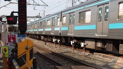 Electric Commuter Train Passing Through Urban Railway Crossing in Kyoto Stock Footage 338420239