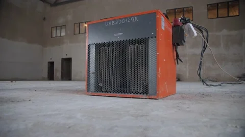 An Electric Construction Heater Blows Warm Air into The Room, Shaking the Cellop Stock Footage 174733987