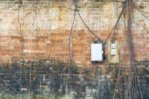 Electric control box on the old brick wall. Stock Photos