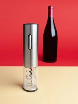 Electric corkscrew for wine opening..In the background there is a bottle of w Stock Photos