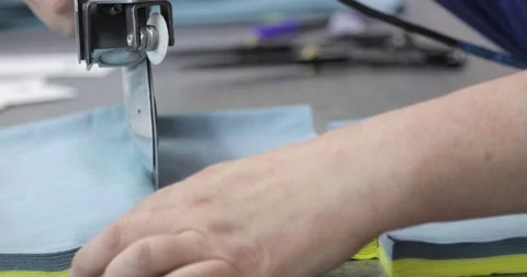 Electric cutter Fabric Machine. Hands of a person cutting fabric in a workshop Stock Footage 157365337