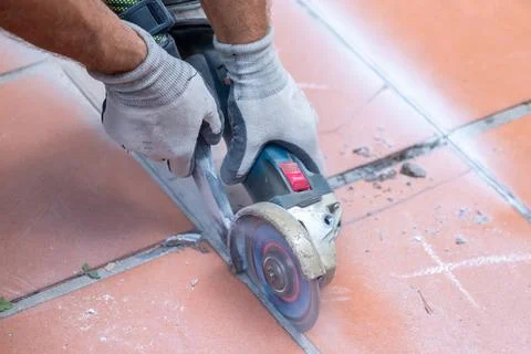 Electric cutting tool slices through ceramic tiles producing construction d.. Stock-Fotos