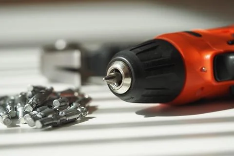 Electric drill and screwdriver bits on a workbench Stock Photos