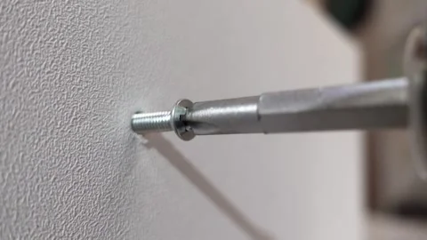 Electric drill driving a self-tapping screw into plywood Stock Footage 326063822