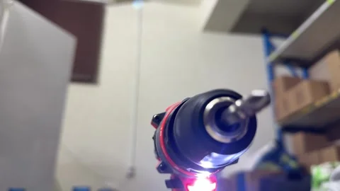 Electric drill with glowing light in close up, power tool ready for work, Stock Footage 337117157